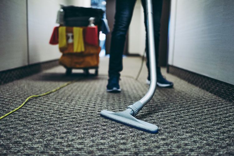 building janitor vacuuming office carpet