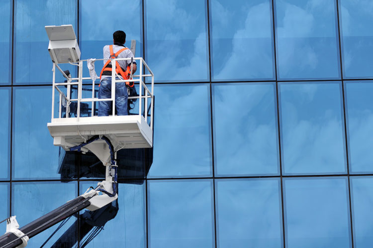 window washer in a hi-lift platform washing building windows